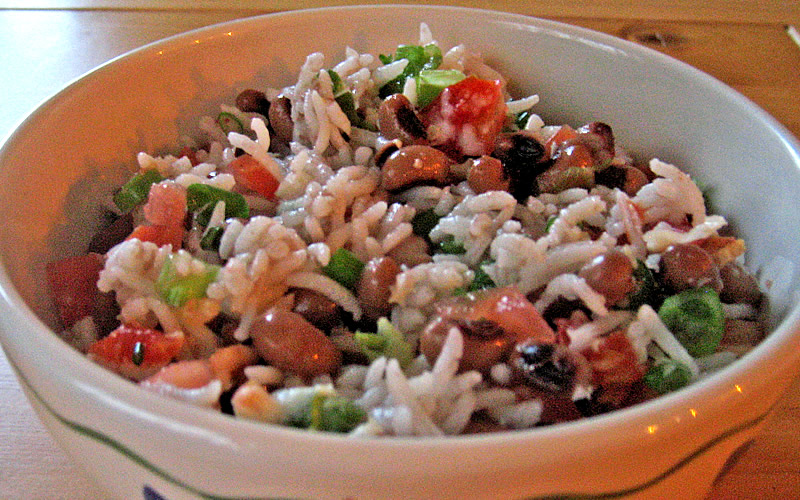 Traditionalists may wonder why tomatoes and scallions are pictured in this version of hoppin' john. We can't give you the answer but will attest to the opinion that the added combination makes the dish extra good -- the editors.