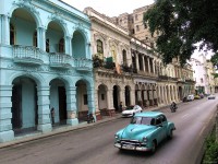 Old cars cruise along the Prado in central Havana day and night.