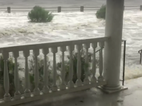 A wave laps at a porch on Murray Boulevard opposite of the Battery along the Ashley River.