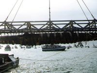 Confederate submarine H.L. Hunley, suspended from a crane during her recovery from Charleston Harbor, Aug. 8, 2000.  Public domain photo via Naval Historical Center.