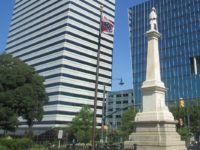 A Confederate battle flag flew next to a monument on the Statehouse grounds in 2012, three years before the flag was removed. Via Wikipedia.